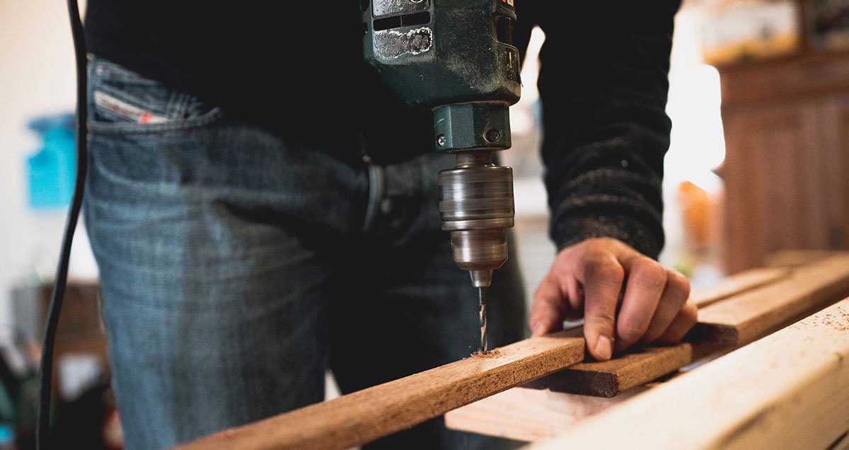 Man drilling wood Man drilling wood